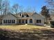 Charming painted brick home with manicured lawn, dormer windows and inviting front entry at 384 Minix Rd, Sharpsburg, GA 30277