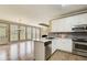 Open concept kitchen with island, stainless appliances, hardwood floors, view of great room at 384 Minix Rd, Sharpsburg, GA 30277