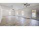A spacious, naturally lit living room features wood-look flooring and access to the outdoors at 384 Minix Rd, Sharpsburg, GA 30277