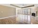 Bright, expansive living room featuring hardwood floors, a fireplace, and an abundance of natural light from large windows at 384 Minix Rd, Sharpsburg, GA 30277