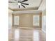 Main bedroom featuring tray ceiling, fan and hardwood floors, two windows for natural light at 384 Minix Rd, Sharpsburg, GA 30277