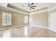 Spacious bedroom with tray ceiling, two windows, hardwood floors and neutral decor at 384 Minix Rd, Sharpsburg, GA 30277