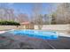 This backyard features a large in-ground pool and a covered area for relaxing at 384 Minix Rd, Sharpsburg, GA 30277