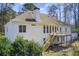 The rear exterior features a deck, stairwell and large windows providing ample natural light at 384 Minix Rd, Sharpsburg, GA 30277