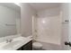 Bathroom with a vanity, toilet, shower and tub combo with white tiling at 4719 Joseph Eli Dr, Snellville, GA 30039