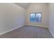 Bedroom with neutral walls, carpet, and a window providing natural light at 4719 Joseph Eli Dr, Snellville, GA 30039