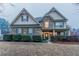 Charming two-story home with a stone and siding facade, manicured bushes, and a well-kept front yard at 4719 Joseph Eli Dr, Snellville, GA 30039