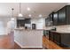 Spacious kitchen features a large island, granite countertops, stainless steel appliances, and hardwood floors at 4719 Joseph Eli Dr, Snellville, GA 30039