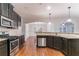 This stylish kitchen features granite countertops, stainless steel appliances, hardwood floors, and recessed lighting at 4719 Joseph Eli Dr, Snellville, GA 30039