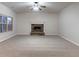 Expansive living room showcases a stone fireplace, neutral carpet, and natural light through a large window at 4719 Joseph Eli Dr, Snellville, GA 30039