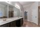 The main bathroom showcases double vanities, a glass-enclosed shower, and a separate soaking tub at 4719 Joseph Eli Dr, Snellville, GA 30039