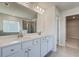 Bright bathroom featuring double sink vanity, soaking tub, and glass-enclosed shower at 124 Felicity Pike, Locust Grove, GA 30248