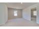 Bright bedroom with carpeted floors, neutral walls and natural light from the window at 124 Felicity Pike, Locust Grove, GA 30248