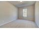 Cozy carpeted bedroom with a neutral color palette and a bright window at 124 Felicity Pike, Locust Grove, GA 30248