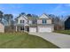 Charming new construction home with a manicured lawn and a three-car garage at 124 Felicity Pike, Locust Grove, GA 30248