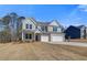 New brick home with an attached three-car garage, complemented by a lush front lawn at 124 Felicity Pike, Locust Grove, GA 30248