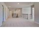 Open hallway with neutral walls, carpet floors, and wrought iron handrails at 124 Felicity Pike, Locust Grove, GA 30248