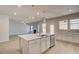 Modern eat-in kitchen with stainless steel appliances, white cabinets, a kitchen island, and pendant lighting at 124 Felicity Pike, Locust Grove, GA 30248