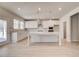 Bright kitchen with stainless steel appliances, white cabinets, and a large island with pendant lighting at 124 Felicity Pike, Locust Grove, GA 30248