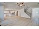 Open concept living room with hardwood floors, ceiling fan, and staircase to the second floor at 124 Felicity Pike, Locust Grove, GA 30248