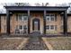 Brick home with a welcoming front porch, chairs, and a stepping stone pathway at 1343 Renee Dr, Decatur, GA 30035