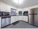 Bright kitchen with stainless steel appliances, white cabinetry, and tile backsplash at 1343 Renee Dr, Decatur, GA 30035