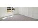 Sunlit bedroom with a large window, neutral gray carpet, and modern wall trim at 1092 Glen Opal Dr, Decatur, GA 30032