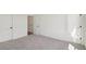 Open bedroom with neutral carpeting, white walls, and bright bathroom at 1092 Glen Opal Dr, Decatur, GA 30032