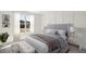 Cozy bedroom with a bed, bench, bedside tables, and neutral accents at 1092 Glen Opal Dr, Decatur, GA 30032