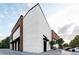 Exterior view of a commercial building featuring a stone facade, wooden accents, and dark metal finishes against a blue sky at 1092 Glen Opal Dr, Decatur, GA 30032