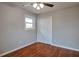 Light-filled bedroom features hardwood floors, a double-door closet and a ceiling fan at 1098 Laurel Nw Ln, Conyers, GA 30012