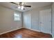 This bedroom features hardwood floors, natural light, a ceiling fan and closet space at 1098 Laurel Nw Ln, Conyers, GA 30012