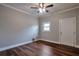 Cozy bedroom with warm wood-look floors, a ceiling fan, and natural light from the window at 1098 Laurel Nw Ln, Conyers, GA 30012