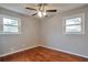 Bright bedroom with hardwood floors, white trim, natural light, and a ceiling fan at 1098 Laurel Nw Ln, Conyers, GA 30012