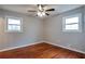 Bright bedroom with hardwood floors, white trim, natural light, and a ceiling fan at 1098 Laurel Nw Ln, Conyers, GA 30012