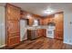 Well-lit kitchen featuring wood cabinetry, granite countertops, and stainless steel appliances at 1098 Laurel Nw Ln, Conyers, GA 30012