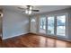 Inviting living room featuring hardwood floors, large windows, and a ceiling fan at 1098 Laurel Nw Ln, Conyers, GA 30012