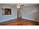Spacious living room with hardwood flooring, ceiling fan, and pass-through to kitchen at 1098 Laurel Nw Ln, Conyers, GA 30012