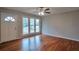 Bright living room with hardwood floors, large windows, and ceiling fan at 1098 Laurel Nw Ln, Conyers, GA 30012