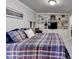 Comfortable bedroom featuring a plaid comforter, built-in shelving, desk area, and recessed lighting at 253 Hailwood Ct, Suwanee, GA 30024