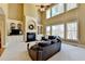 Bright living room with built-in shelves surrounding the fireplace, tall windows, and cozy seating at 253 Hailwood Ct, Suwanee, GA 30024