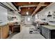 Unfinished basement with exposed ceiling, workbench, and ample storage at , Lilburn, GA 30047