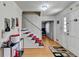 Bright foyer with hardwood floors, staircase with metal railing, and modern light fixture at , Lilburn, GA 30047