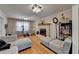 Bright living room with hardwood floors, fireplace, two sofas and exercise equipment at 423 James Sw St, Lilburn, GA 30047