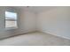 Well-lit bedroom with neutral carpet and a window with a view of the outdoors at 128 Felicity Pike, Locust Grove, GA 30248