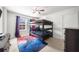 Bright bedroom with neutral tones, bunk bed, ceiling fan, and a video game theme at 1380 Avalon Creek Rd, Sugar Hill, GA 30518