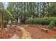 Relaxing backyard offers an outdoor kitchen, stone pathway, bench, and lots of mature foliage at 2310 Gracehaven Way, Lawrenceville, GA 30043