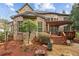 Beautiful brick home exterior featuring a charming backyard with a wood pergola and lush landscaping at 2310 Gracehaven Way, Lawrenceville, GA 30043
