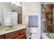 Bathroom with warm neutral tones, single sink vanity, and tiled shower-over-tub at 2310 Gracehaven Way, Lawrenceville, GA 30043