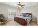 Comfortable bedroom featuring a ceiling fan, large windows, and a decorative chair at 2310 Gracehaven Way, Lawrenceville, GA 30043